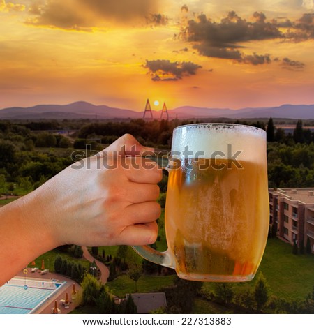 Glass of German beer served on the hotel terrace in Budapest at sunset.