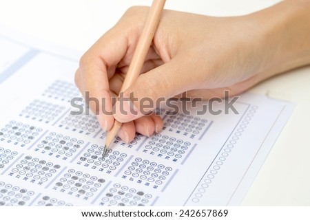 Standardized test form with answers bubbled in and a pencil, focus on anser sheet
