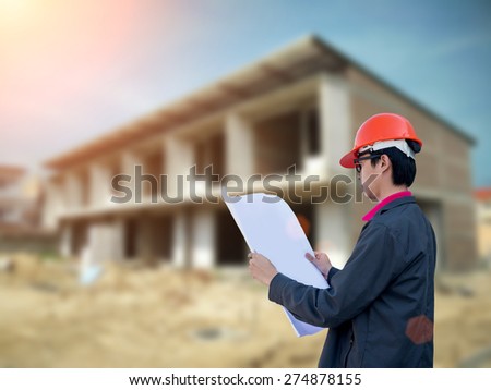 Engineers stands at a housing construction.