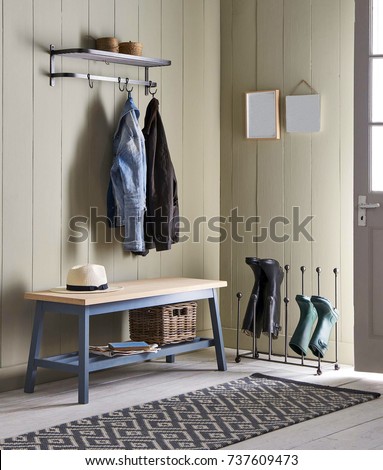Interior of bright hallway home. Hanging clothes on door