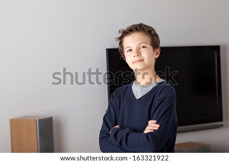 Teenage Boy in a modern living room with a flat-screen TV in the background