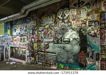Seattle, USA, JANUARY 2014: A wall full of grafitti in a dark alleyway next to the Farmers market in Seattle downtown. The area is dominated by tourists. January 18, 2014