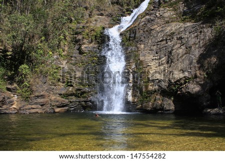 Waterfall in mountain falls in deep well water crystal