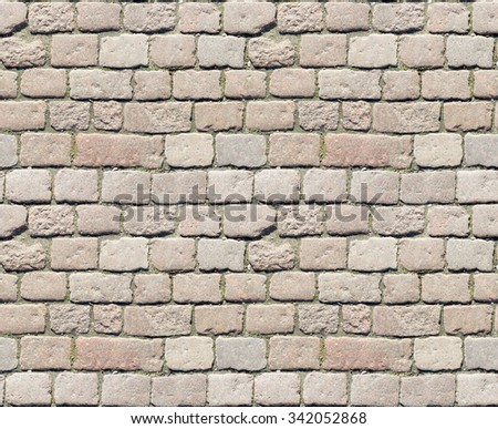Stone pavement texture. Granite cobblestoned pavement background. Abstract background of old cobblestone pavement close-up. Perfect tiled and close up for all sides.