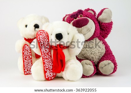 sweet toys / polar doll bears and teddy bear with their arms around each other isolated on a white background
