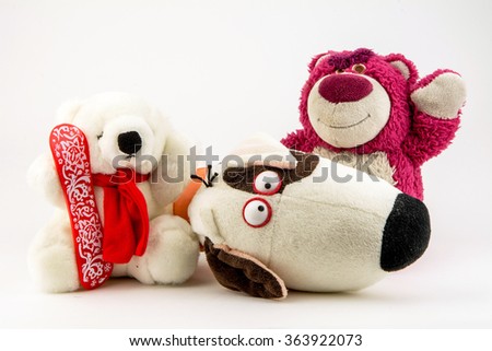 sweet toys / polar doll bears and teddy bear with their arms around each other isolated on a white background / toy teddy bear isolated on white / dog and teddy bear with their arms around each other