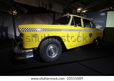 PARIS - OCTOBER 13 : People look at a Yellow cab taxi of new york at the 2008 Paris Motor Show October 13, 2008 in Paris. The show attracts more of one million people every 2 years