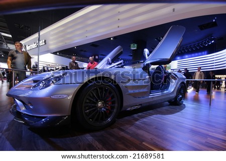 PARIS - OCTOBER 13: People look at the Mercedes SLR Roadster at the 2008 Paris Motor Show October 13, 2008 in Paris. The show attracts more one million people every 2 years..