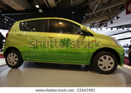 PARIS - OCTOBER 13 : People look at the  ecologic car at the 2008 Paris Motor Show October 13, 2008 in Paris. The show attracts more of one million people every 2 years
