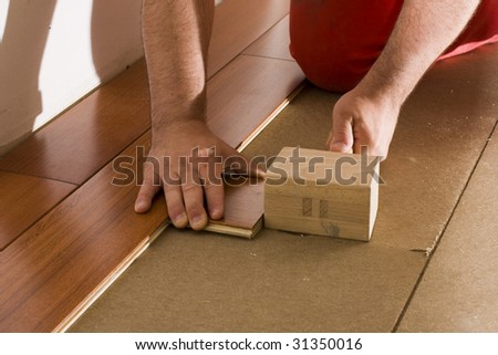 worker install a hardwood floor