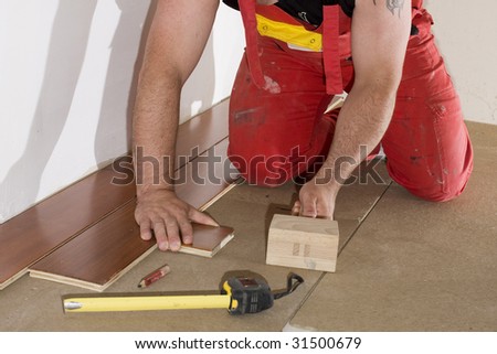 worker install a hardwood floor