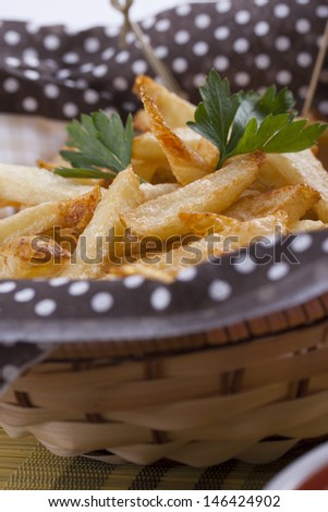 Home made crispy potato french fries in a basket