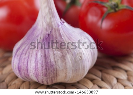 Close up picture of health vegetables - tomato and a garlic bulb