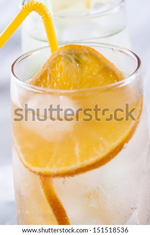 Fresh fruit and water drink with a sliced fruits - kiwi, orange, mint herb and ice.