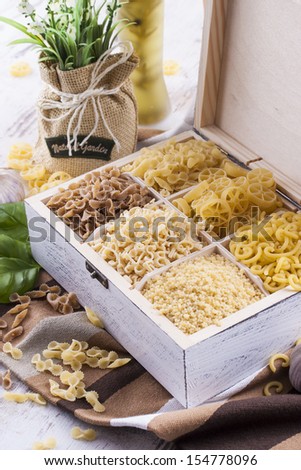 Close up photo of a noodles in a white box on a brown dish clothe and bright background.