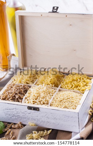 Close up photo of a noodles in a white box on a brown dish cloth and bright background.