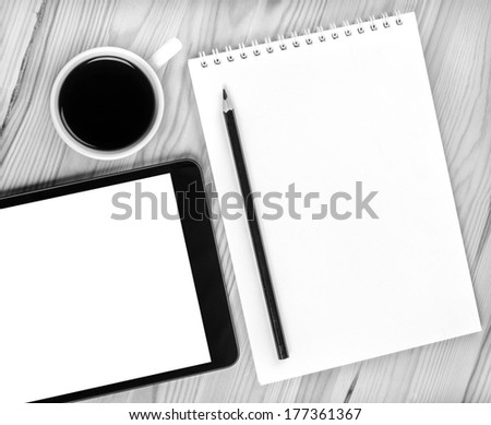 Touch screen device, notepad,  cup of coffee on wood