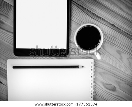 Touch screen device, notepad,  cup of coffee on wood
