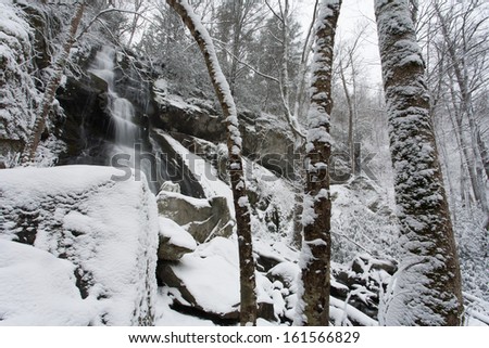 A waterfall over a cliff in the snow.  Henwallow Falls, Great Smoky Mountains National Park, TN, USA.
