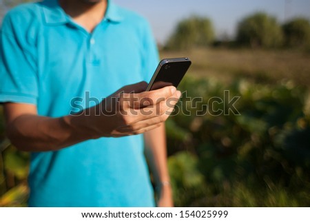 Man Using A Mobile Smartphone In Nature