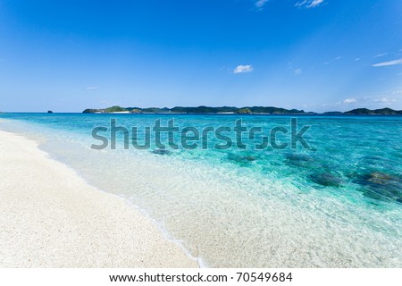 Clear blue water wave lapping white sand tropical beach on the deserted island in the coral lagoon, Kerama islands, Okinawa, Japan