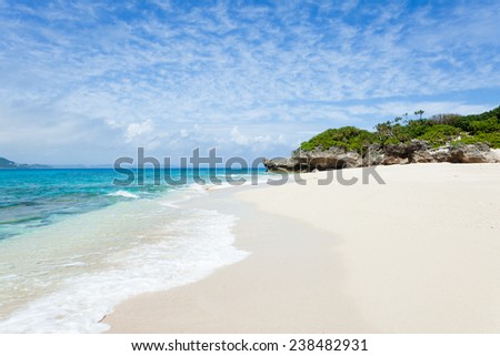 Clear blue water lapping on a deserted tropical island beach, Okinawa, Japan
