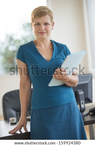 Portrait of confident businesswoman holding files
