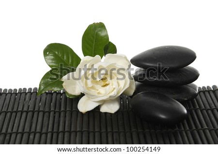 Single of gardenia flower with stone on bamboo mat
