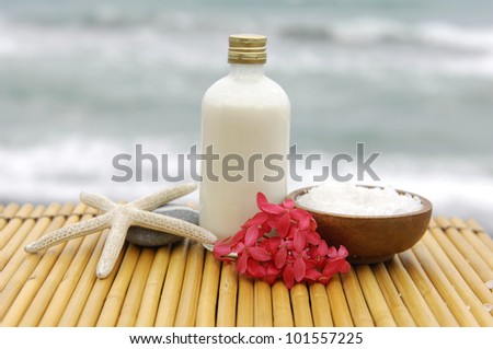 Zen concept -Stones and massage oil with salt in wooden bowl