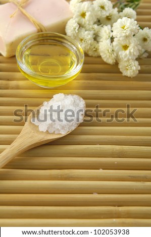 natural handmade soap and massage oil salt in wooden bowl on bamboo mat