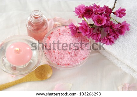 Soft towel and plum flower. candle, salt in bowl ,massage oil on towel
