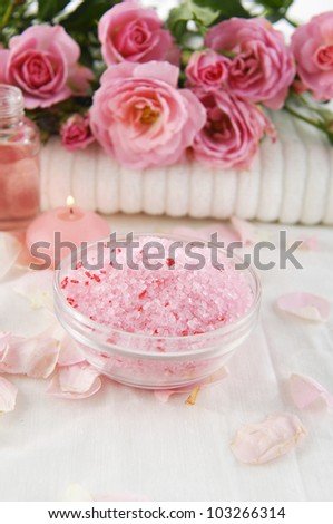 branch rose on towel with salt in bowl on white towel