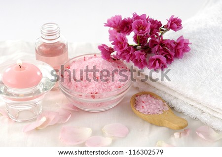 Spa setting with Pink cherry blossom with towel ,salt in bowl, massage oil