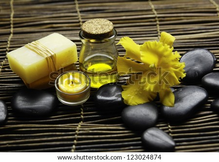 Zen rock and beautiful orchid ,candle, soap on mat