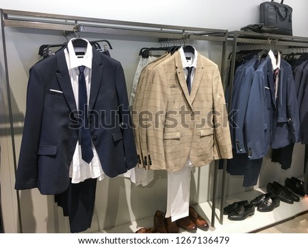 Men\'s suits with shirts, shoes,hat, handbag in shop