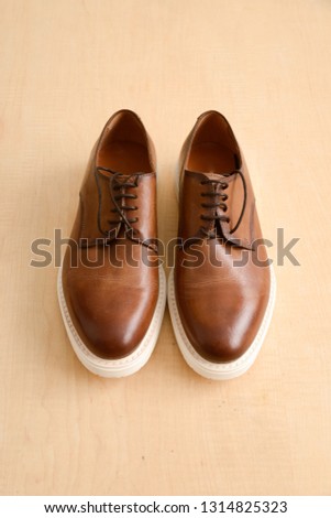 Brown Leather Men's Shoes On Wooden Background. Top View.
