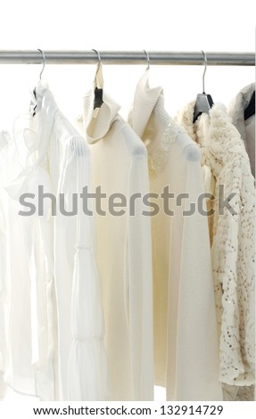 Fashion female white clothing hanging on hangers