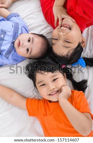 happy kids ,baby on the floor laying on