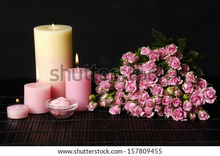 Spa feeling with pink and white Candles and bouquet roses on mat