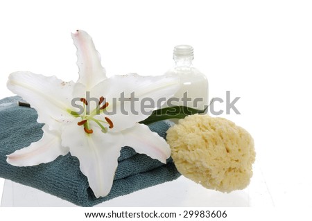spa objects and flower Madonna lily over white