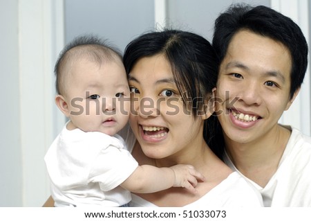 happy asian family in living room
