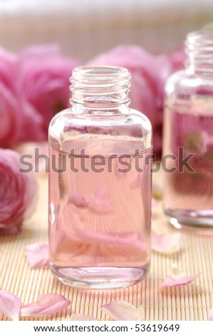 Aromatic massage oil and pink gardenia flowers