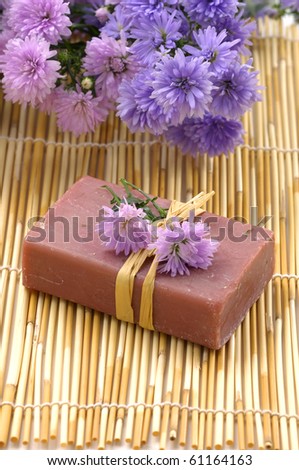 Spa composition. Soap and chrysanthemums on bamboo stick straw mat