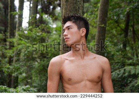 Image of handsome man standing over mountain forest,
