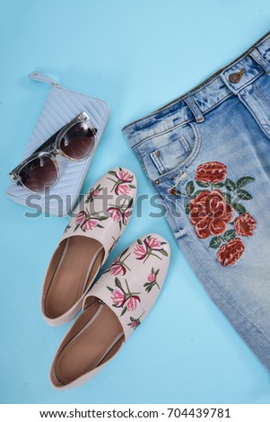Fashion. Summer woman accessories-embroidery floral jeans , bag-,shoes,sunglasses-blue background