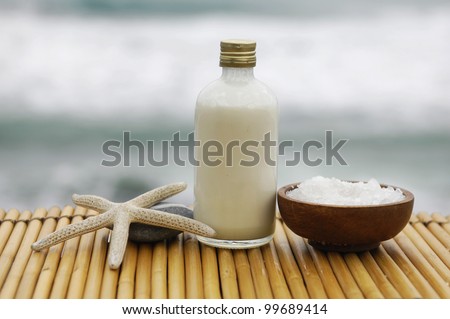 Zen concept -Stones and massage oil with salt in wooden bowl