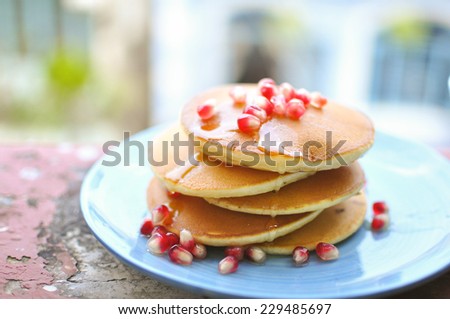 Summer pancake with pomegranate (A thin, flat cake of batter, usually fried and turned in a pan. Pancakes are usually eaten with syrup or rolled up with a filling)