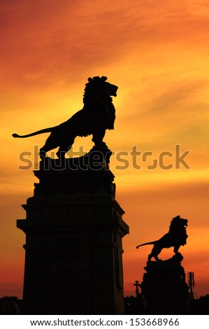 VIENNA, AUSTRIA - JUNE 9: Nussdorf weir with its lion statues silhouetted at sunset shown on 9 June 2011 in Vienna. The weir is a well known landmark by Otto Wagner, the lions are by Rudolf Weyr.