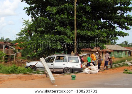 AKURE, NIGERIA - MAY 11, 2012: Nigerian people next to a car accident, in the dangerous roads of the Ondo State in the east of Nigeria, on May 11, 2012