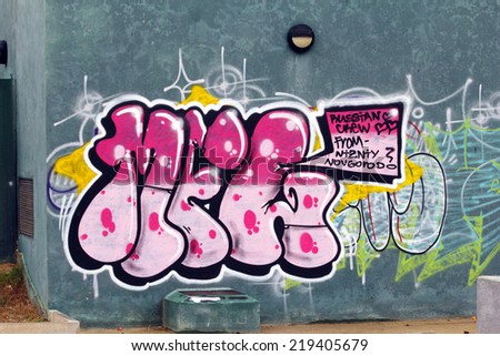 SALOU, SPAIN - SEPTEMBER 21, 2014: Anonymous graffiti image, shows an abstract pink text in a public walll in Salou on September 21, 2014.